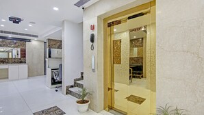 A hotel lobby with a reception desk, a phone, and a plant. - Treebo Jannat Residency (New Delhi)