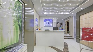 A reception desk with a digital screen displaying 'JANAT Residency'. - Treebo Jannat Residency (New Delhi)