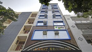 A multi-story building with balconies, air conditioning units, and a sign for 'Jannat Residency' with 'treebo' branding. - Treebo Jannat Residency (New Delhi)