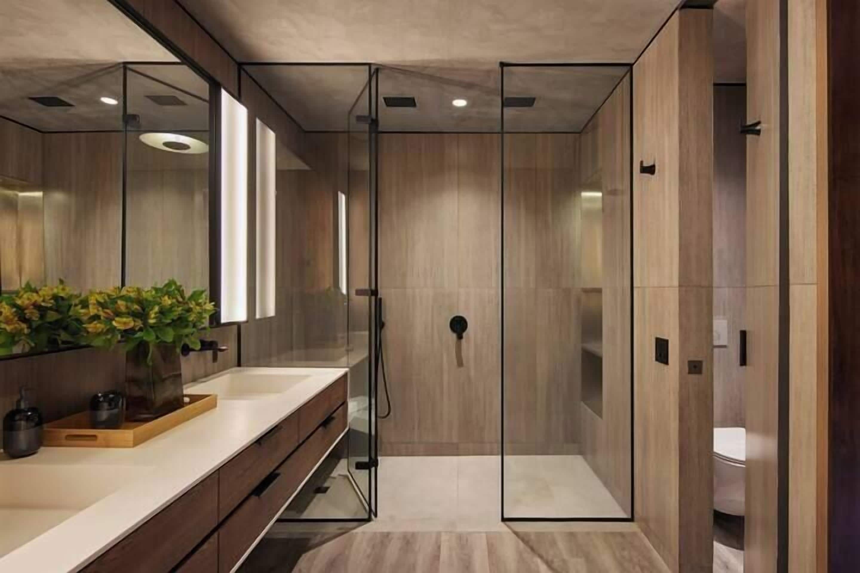 A modern bathroom with a glass-enclosed shower, a wooden vanity, and a large mirror.