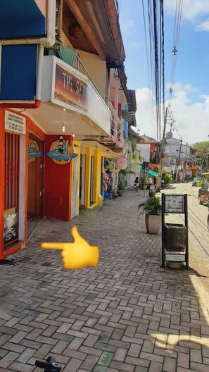 A street with shops and a sign for 'The Sea'.