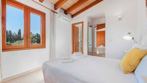 A bedroom with a large bed, wooden beams, a window with curtains, and a mirror. - Palmestar, Finca 5StarsHome Mallorca (Puerto Pollensa)