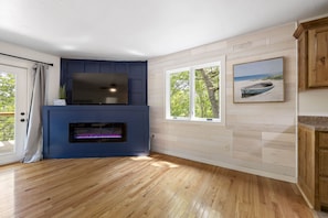 Cozy up by the fireplace and enjoy the view from the large window.
