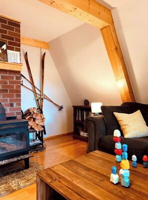 Cozy living room with a brick fireplace, sofa, and coffee table.
