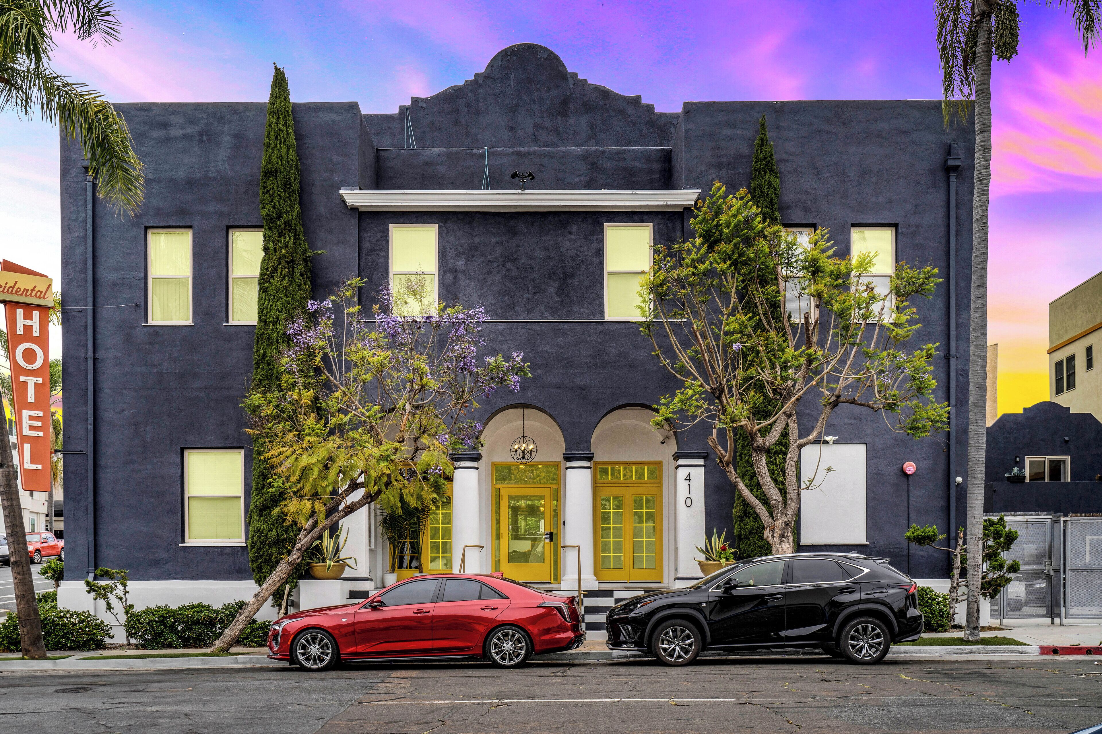 A modern building with a black facade, yellow doors, and a number '410' on the side.
