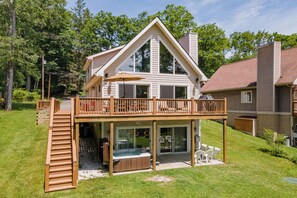 A two-story house with a deck, a hot tub, and a covered patio area. - Cozy Lake Escape Near State Park & Slopes (Swanton)