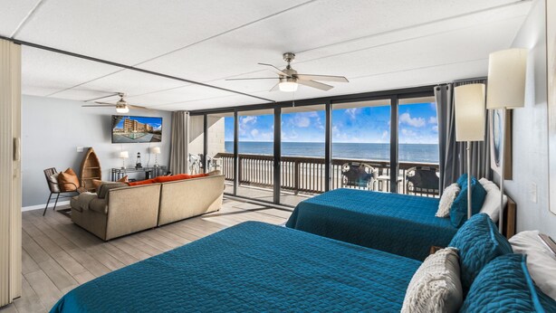 A room with two beds, a desk, and a view of the ocean. - Gulf Shores Condo 403 Gorgeous 4th Floor Beachfront View (Port Aransas)