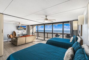 A room with two beds, a desk, and a view of the ocean. - Gulf Shores Condo 403 Gorgeous 4th Floor Beachfront View (Port Aransas)