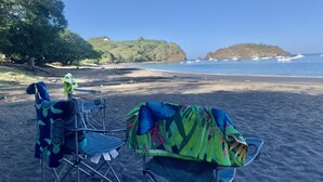 Two camping chairs on a sandy beach with a view of the ocean and a small island in the distance. - Beachfront Community Ocean View 2Br/2Ba in Los Almendros, Playa Ocotal (Playa Ocotal)