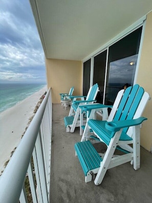Relax in style with ocean views from this balcony, featuring four Adirondack chairs.