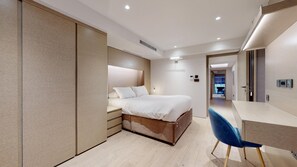 Relax in a spacious room with a large bed, wardrobe, and flat-screen TV.