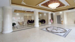 A spacious lobby with a grand chandelier, marble flooring, and classical columns. - Zhaoqing Dengfeng Business Hotel B (Huaiji)
