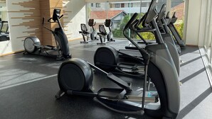 A modern gym with stationary bikes, treadmills, and a rowing machine. - Casa de Elena – Tranquility, Peace & Relaxation (Bucerias)