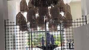 A modern interior with a black metal gate, hanging woven light fixtures, and a tiled floor. - Casa de Elena – Tranquility, Peace & Relaxation (Bucerias)