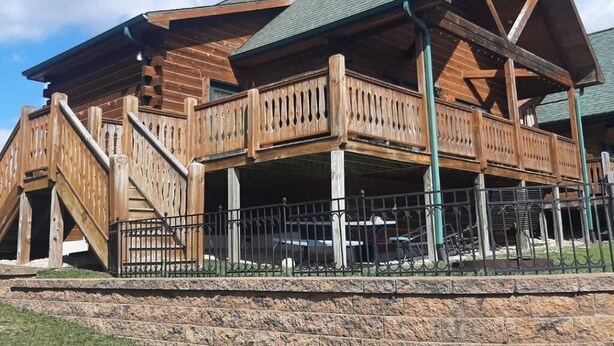 A wooden building with a balcony and a staircase leading to an upper level. - Cozy 3 Bed 2 Bath Cabin located next to Three Bears Resort in Warrens Wisconsin  (Warrens)