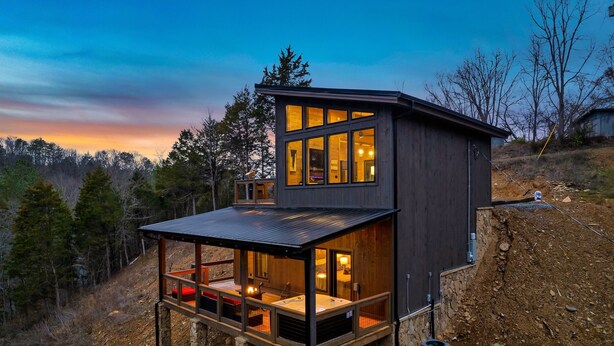 A modern two-story cabin with a balcony, large windows, and a hot tub. - Perfect Modern Cabin for Couples Hot Tub Indoor Fireplace Pet friendly (Sevierville)