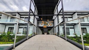 Un edificio moderno con un paseo techado que conduce a la entrada principal.