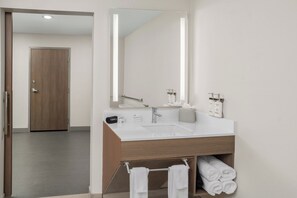 A modern bathroom with a white sink, a large mirror, and a wooden vanity. - Holiday Inn Express Hattiesburg West Univ Area by IHG (Hattiesburg)