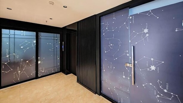 A modern hotel room with a large window, a dark-colored door with a handle, and a ceiling with recessed lighting. - No.8 Season Hotel (Shenzhen Dongmen Hubei Subway Station Branch) (Shenzhen)