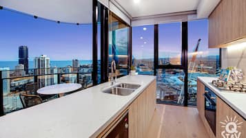 Apartamento, 3 quartos | Cozinha privada | Geladeira grande, micro-ondas, fogão, cooktop