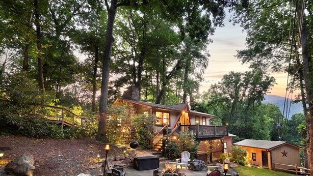 A rustic cabin with a stone exterior, a deck, and a fire pit area. - High-Speed WiFi, Pool Table, private HOT TUB, Fire Pit, Game Room, 2 Kitchens! (Maggie Valley)
