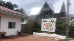 A building with a sign reading "Tequila Cove" and a red-tiled roof. - Tequila Cove (Panglao)