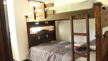 A bunk bed with a wooden headboard and a ladder.