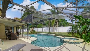 A covered outdoor swimming pool with lounge chairs and a patio area. - Fully Fenced, Extra Large Lot, Private Pool & Spa Close to Attractions, Restaurants & Supermarkets (PG2200) (Clermont)