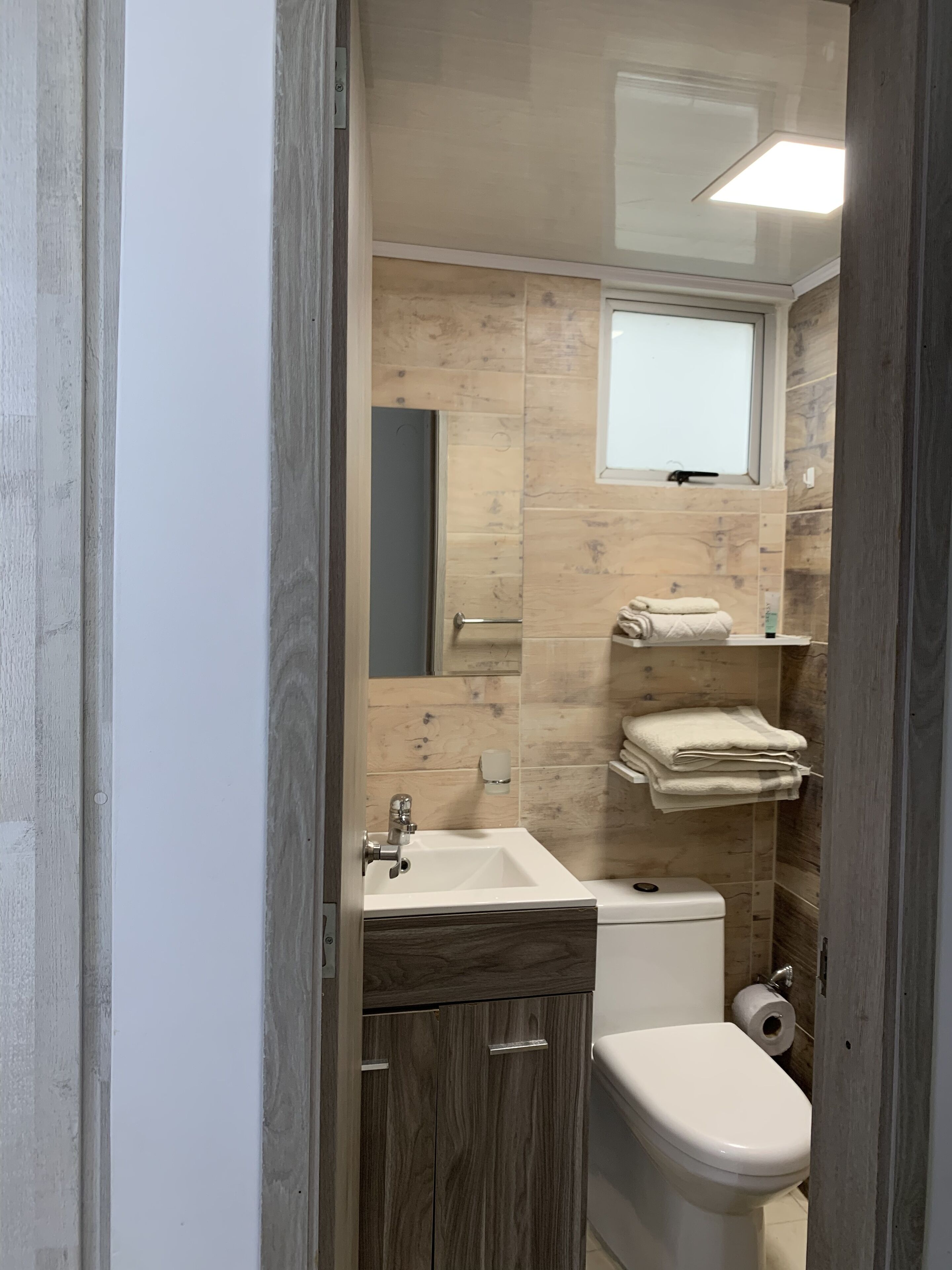 Shower, hair dryer, towels, toilet paper