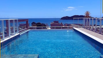 Outdoor pool, open 9:00 AM to 10:00 PM, pool umbrellas, sun loungers