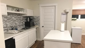 A compact kitchen with white cabinets, a black stove, a microwave, and a refrigerator. - Stylish 1BR unit in Bedford, only 15 min to downtown Halifax. Near shopping area (Halifax)