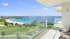 A balcony with a clear view of a beach and ocean. - A-1003 Stunning one bedroom apartment (Cupecoy)