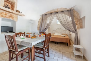 Dining room and double bed in the alcove