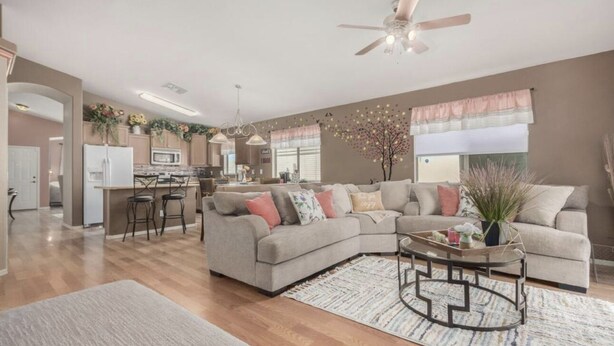 A spacious living room with a large sectional sofa, a coffee table, and a dining area with chairs. - Pet-Friendly and Family-Friendly (Casa Grande)