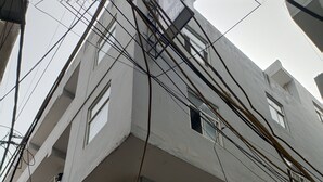 A multi-story building with visible balconies and air conditioning units. - Dalton Hotels  (New Delhi)
