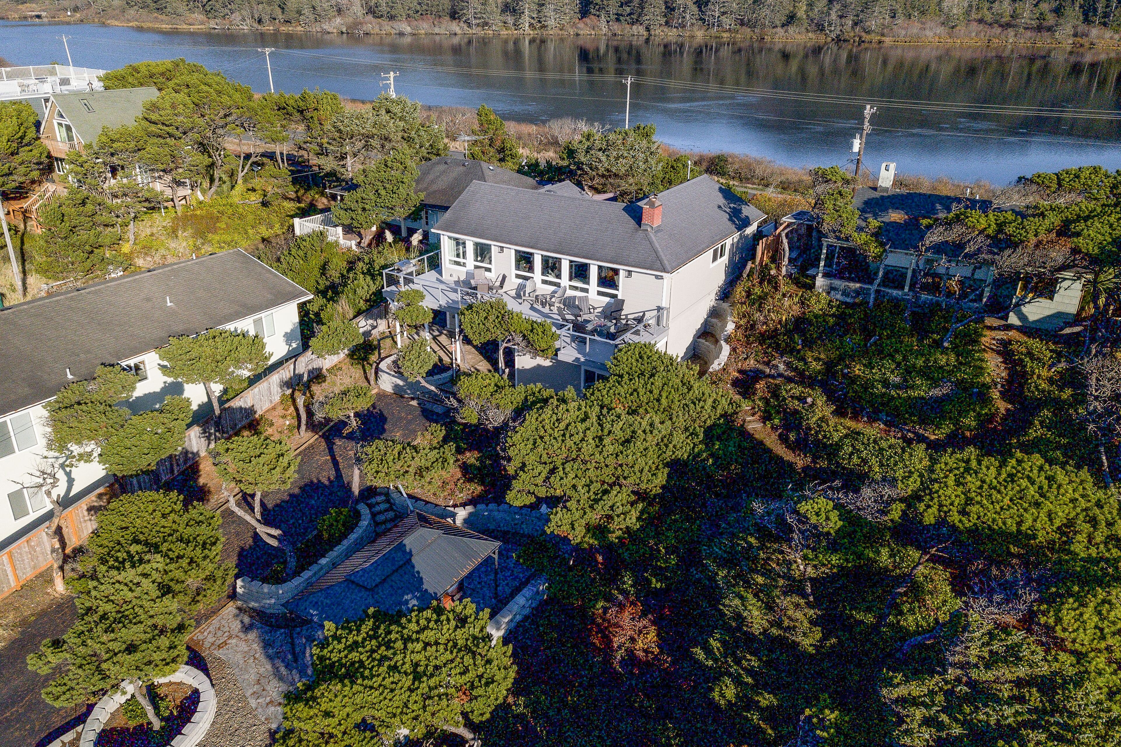 Renovated lake/ocean-view retreat with hot tub, outdoor living & fireplace