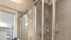 A modern bathroom with a large white sink, a glass shower enclosure, and a mirror above the sink. - Ryans Pocket (Ibiza Town)