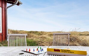 A wooden deck with a board game and a Ludo box.