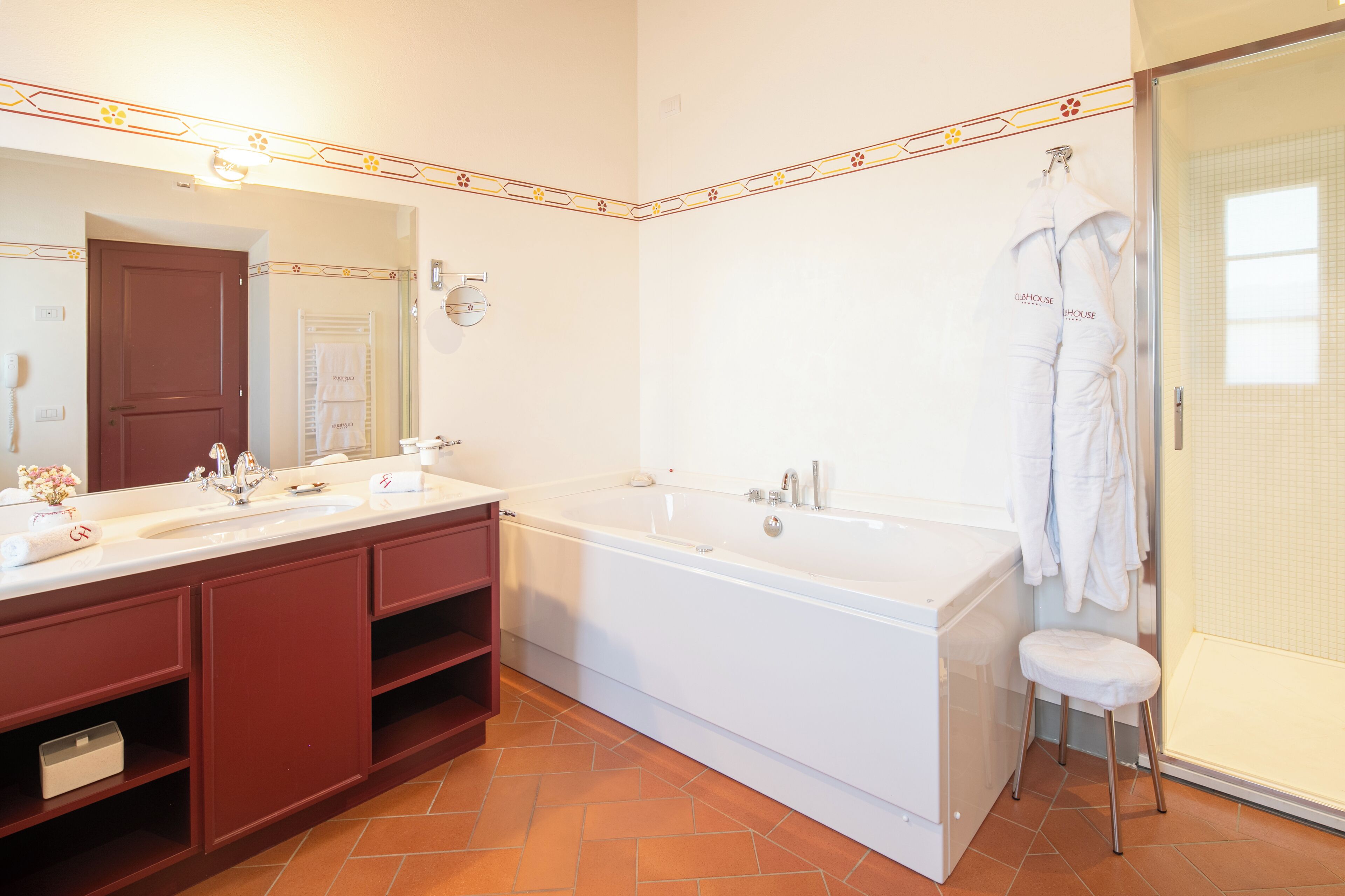 A modern bathroom with a large bathtub, a double sink vanity, and a walk-in shower.
