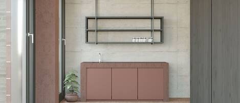 Un baño moderno con techo de concreto, un lavabo minimalista y un piso estampado.