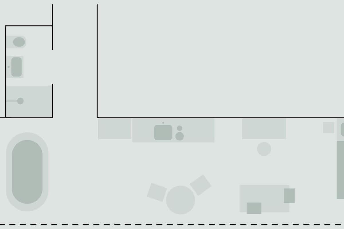 A hotel layout with a large central room, a smaller room to the left, and a bathroom area.