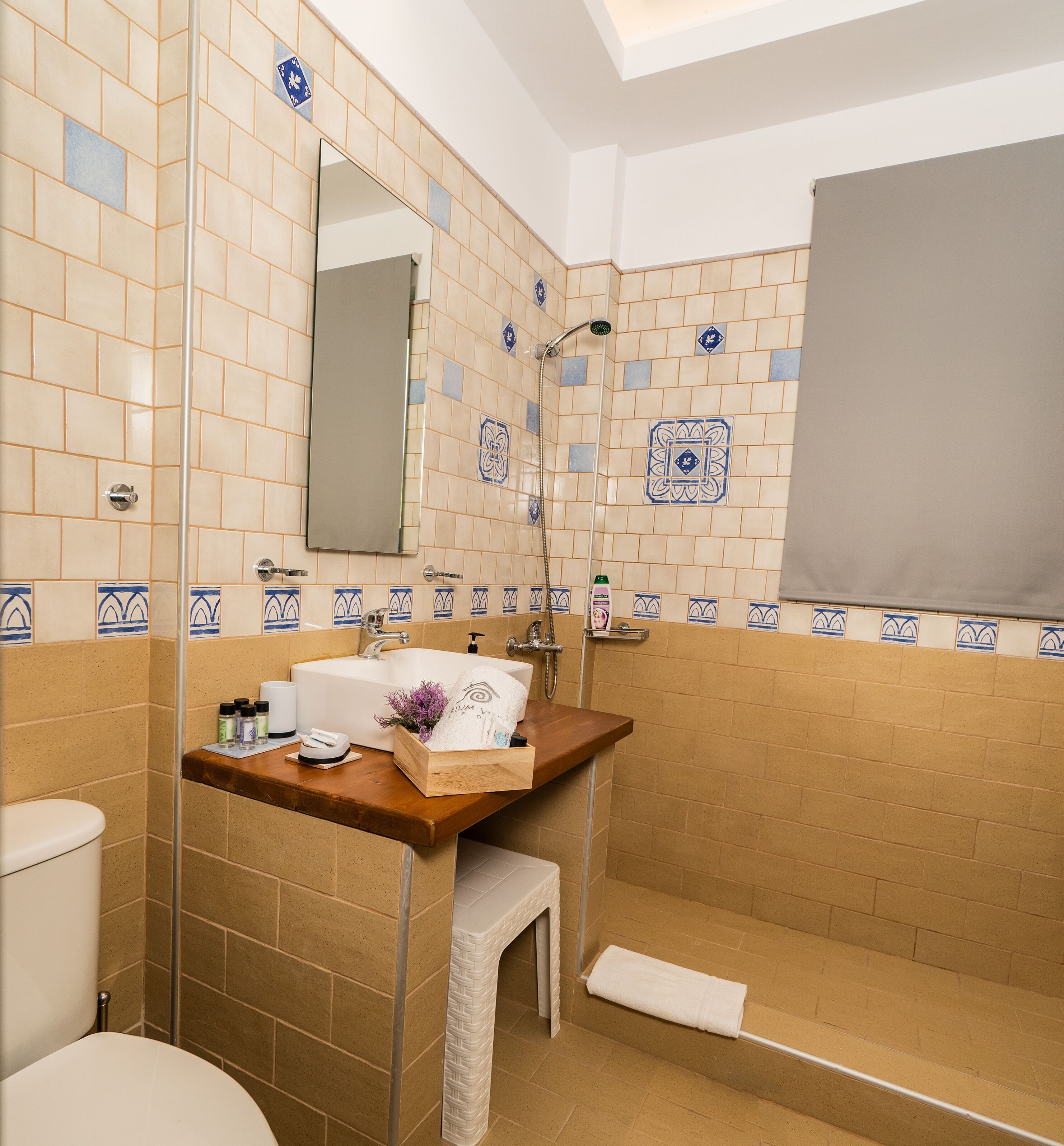 A bathroom with a shower, toilet, and sink.