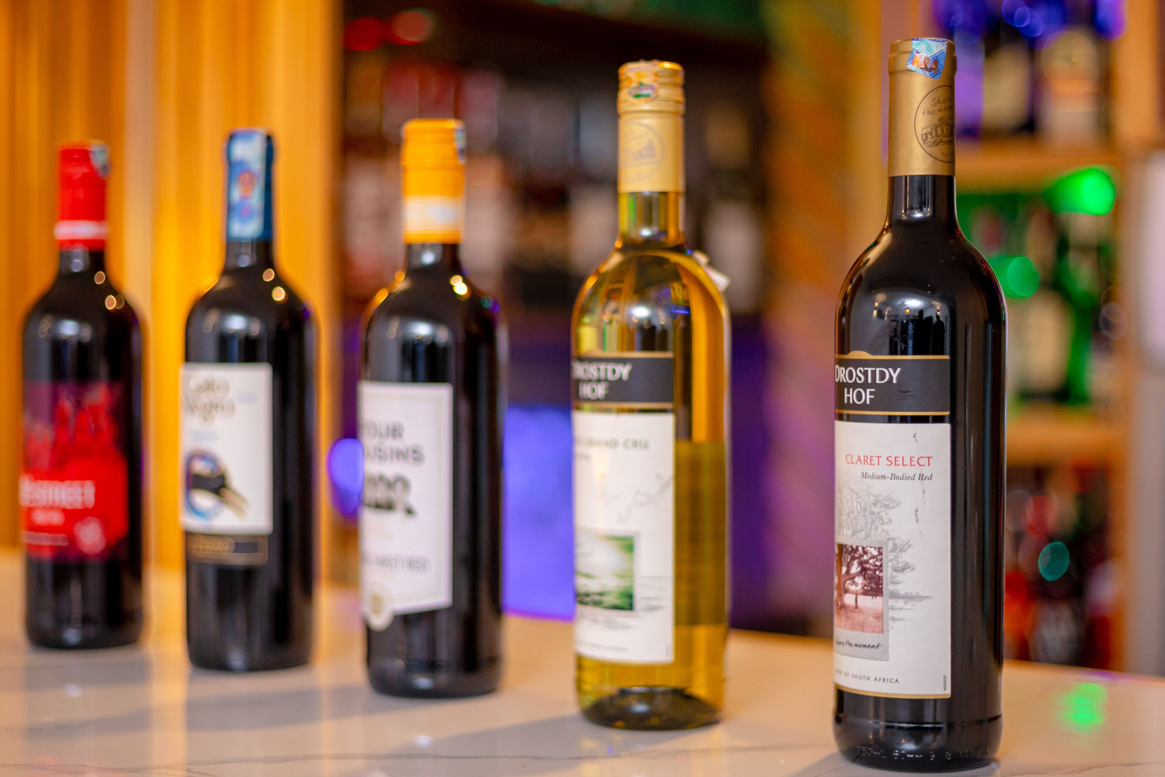 A selection of wine bottles on a bar counter.