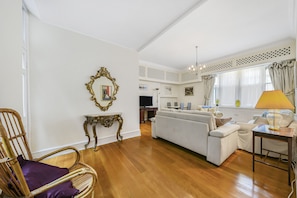 Relax in this stylish living room with a sofa, wicker chair, and side table.