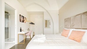 A modern bedroom with a large bed, a desk, and a shower. - SHoruq (Marsala)