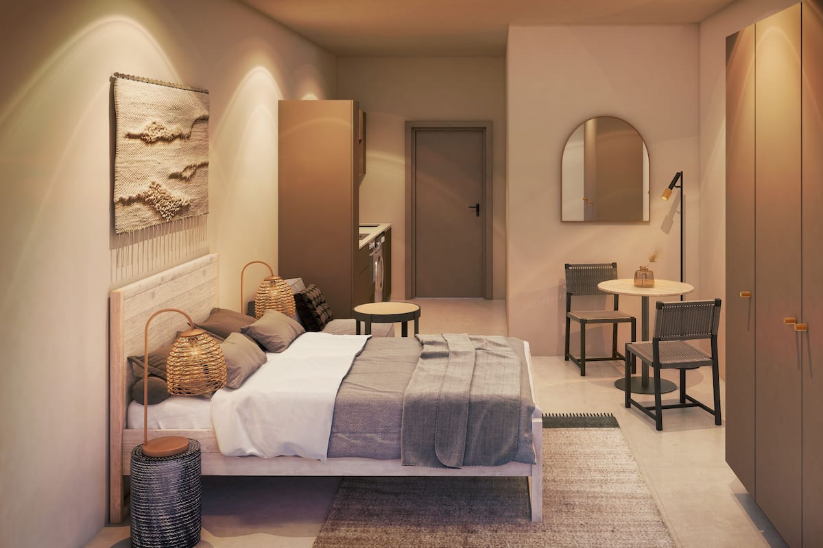 Een moderne slaapkamer met een bed, nachtkastjes, een stoel, een bureau en een kledingkast.
