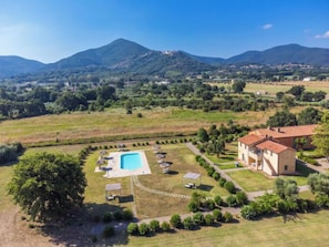 A villa with a swimming pool, surrounded by a well-maintained garden and a view of the mountains. - Quercia Alta by Interhome (Scarlino)