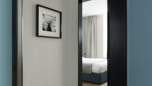 A bedroom with a bed, a bedside table, and a framed picture on the wall. - Brera Apartments Alla Scala (Milan)