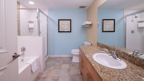 A modern bathroom with a shower, toilet, and sink.
