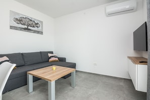 Family Apartment A1 | Living area | 100-cm flat-screen TV with satellite channels, TV